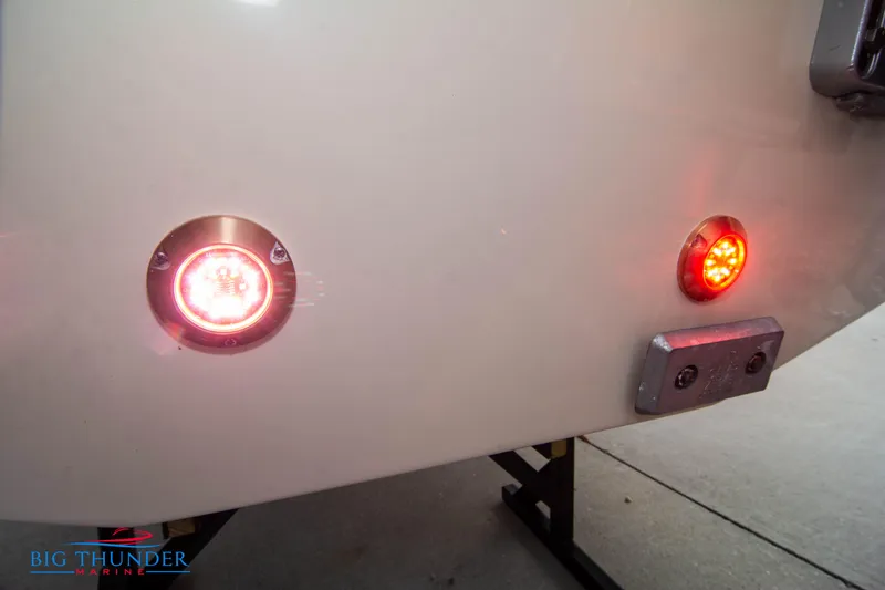 Slide: The Image of 2024 Chris-Craft CALYPSO 35 CP boat stern with illuminated red lights. - 13