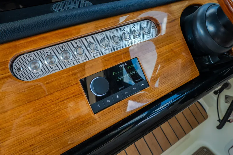 Slide: The Image of 2024 Chris-Craft Calypso 35 dashboard with wood finish and control panel. - 33