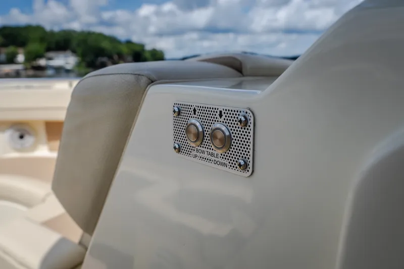 Slide: The Image of 2024 Chris-Craft Calypso 35 boat interior with control panel for table adjustment. - 45