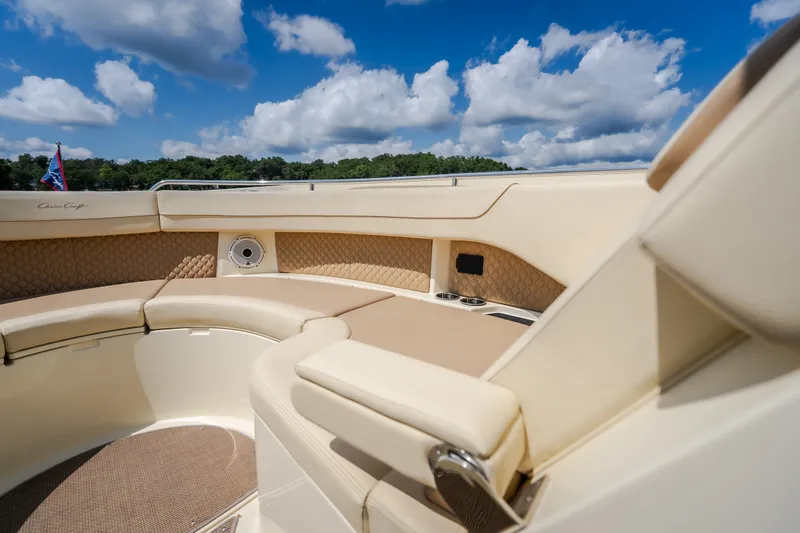 Slide: The Image of Luxurious seating on 2024 Chris-Craft Calypso 35 boat under a bright blue sky. - 47