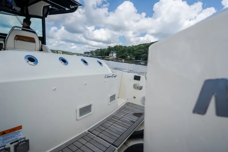 Slide: The Image of 2024 Chris-Craft Calypso 35 boat on water, showcasing deck and seating area. - 62