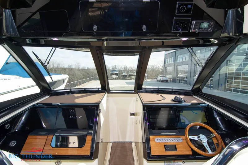 Slide: The Image of 2024 Chris-Craft CALYPSO 35 CP helm with modern controls and panoramic windows. - 37