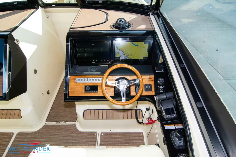Slide: The Image of 2024 Chris-Craft CALYPSO 35 CP boat helm with wooden steering wheel and modern navigation system. - 38