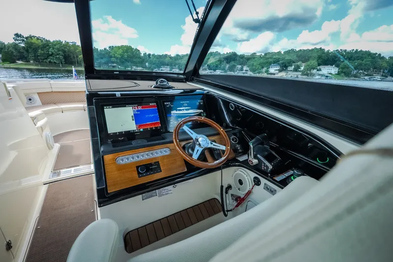 Slide: The Image of 2024 Chris-Craft Calypso 35 helm with modern navigation displays and luxurious seating. - 61