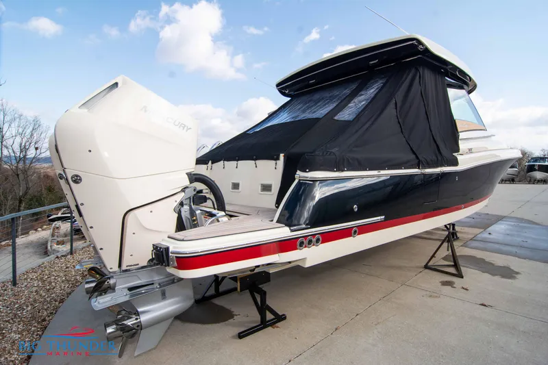 Slide: The Image of 2024 Chris-Craft CALYPSO 35 CP boat with covered cabin and powerful outboard engine. - 5