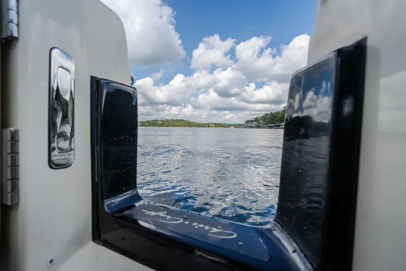 Slide: The Image of View from 2024 Chris-Craft Calypso 35 boat, overlooking serene lake and cloudy sky. - 25