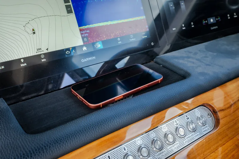 Slide: The Image of Dashboard of 2024 Chris-Craft Calypso 35 with Garmin display and smartphone. - 34