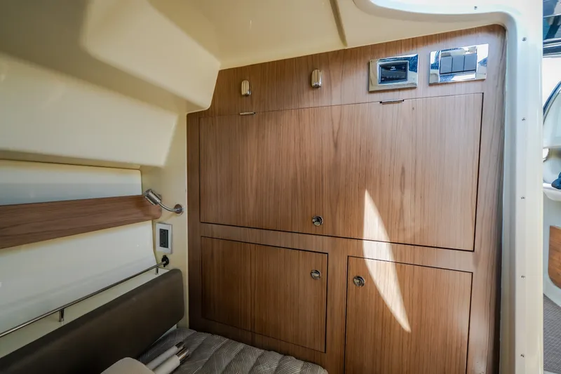 Slide: The Image of 2024 Chris-Craft Calypso 35 cabin interior with wooden cabinetry and modern design. - 55