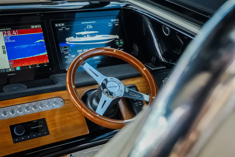 Slide: The Image of 2024 Chris-Craft Calypso 35 dashboard with wooden steering wheel and digital displays. - 29