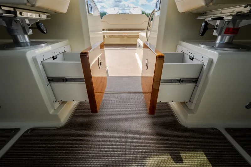 Slide: The Image of 2024 Chris-Craft Calypso 35 interior with open storage drawers and seating area. - 56