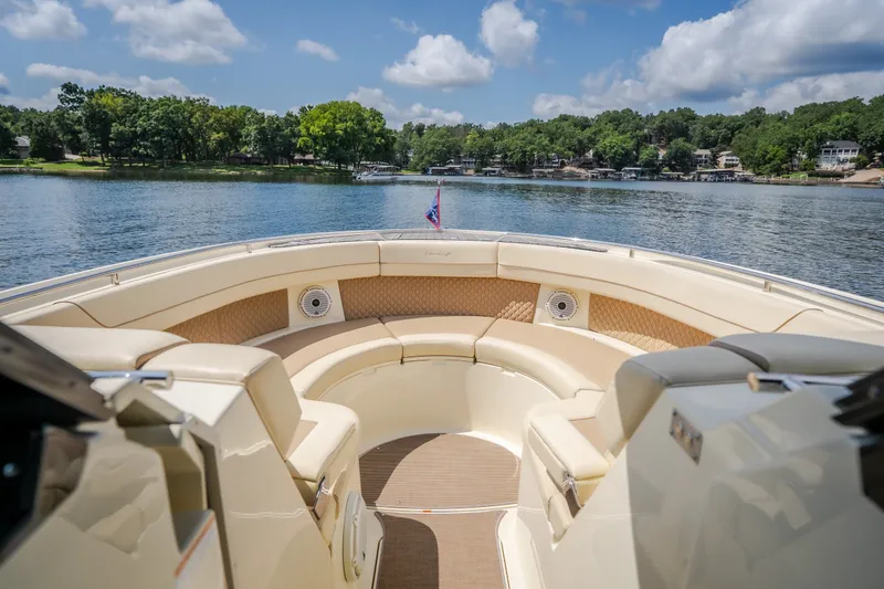 Slide: The Image of 2024 Chris-Craft Calypso 35 boat with luxurious seating on a serene lake. - 44
