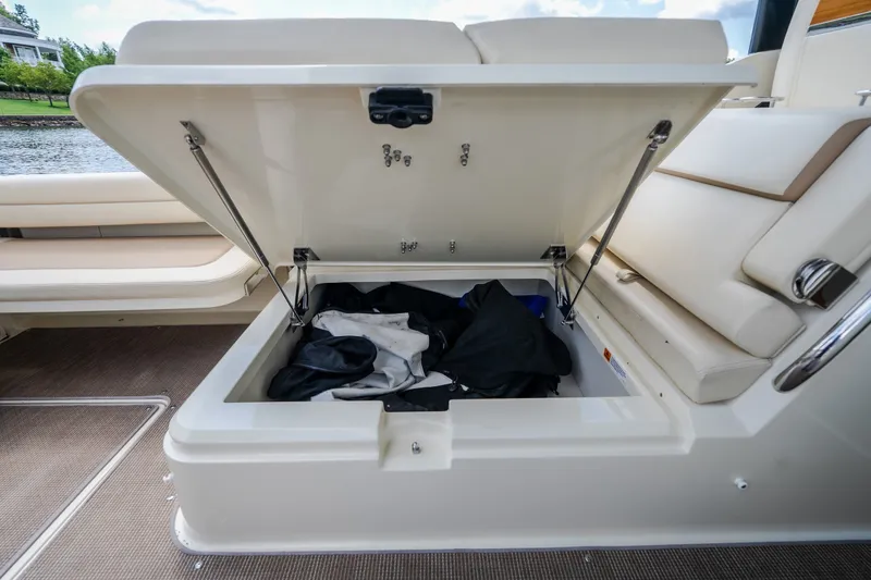 Slide: The Image of 2024 Chris-Craft Calypso 35 boat storage compartment open, revealing interior space. - 22