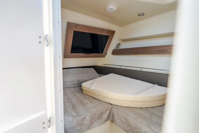 Slide: The Image of 2024 Chris-Craft Calypso 35 cabin interior with bed and mounted TV. - 54