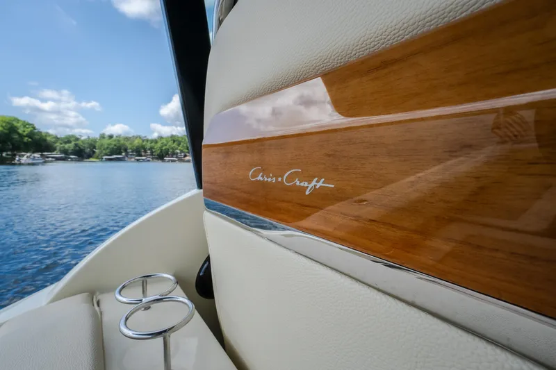 Slide: The Image of 2024 Chris-Craft Calypso 35 interior detail with wood finish, lake view in background. - 64