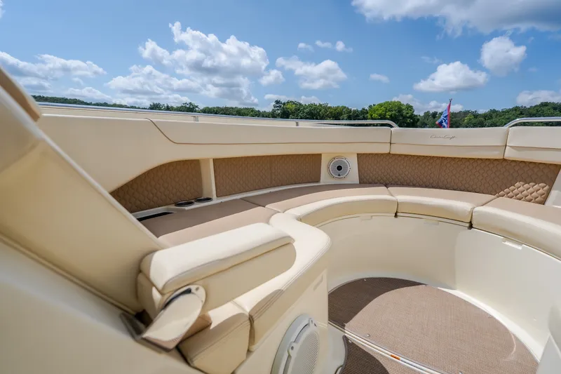 Slide: The Image of Luxurious seating area on 2024 Chris-Craft Calypso 35 boat under a clear sky. - 48