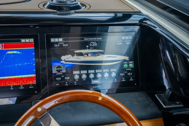 Slide: The Image of Dashboard of 2024 Chris-Craft Calypso 35 with advanced navigation displays. - 35