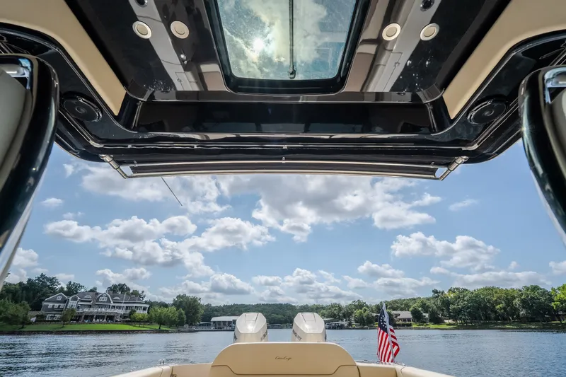 Slide: The Image of 2024 Chris-Craft Calypso 35 boat interior view with lake and sky background. - 58