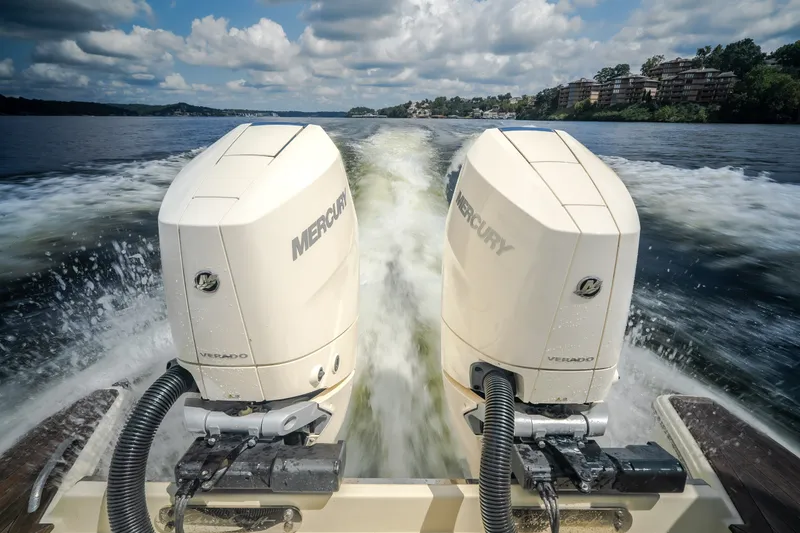 Slide: The Image of 2024 Chris-Craft Calypso 35 with dual Mercury Verado engines on a scenic waterway. - 15