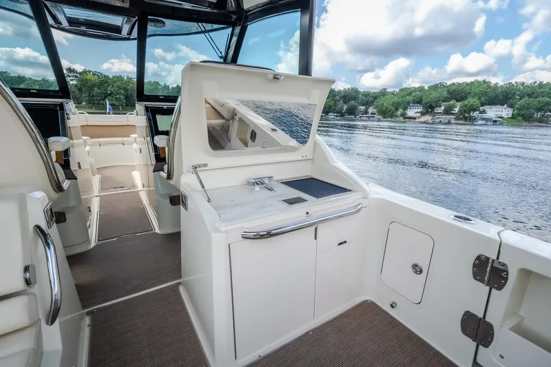 Slide: The Image of 2024 Chris-Craft Calypso 35 interior with open deck, lake view, and modern amenities. - 23
