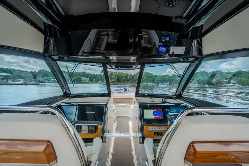 Slide: The Image of 2024 Chris-Craft Calypso 35 cockpit with modern navigation systems and lake view. - 28