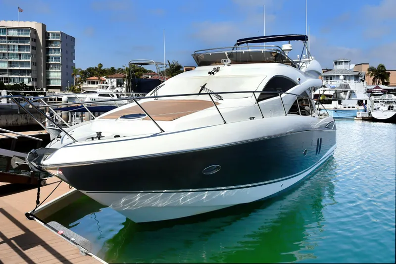 Slide: The Image of 2006 Sunseeker Manhattan 50 yacht docked in marina, clear sky, calm water. - 1