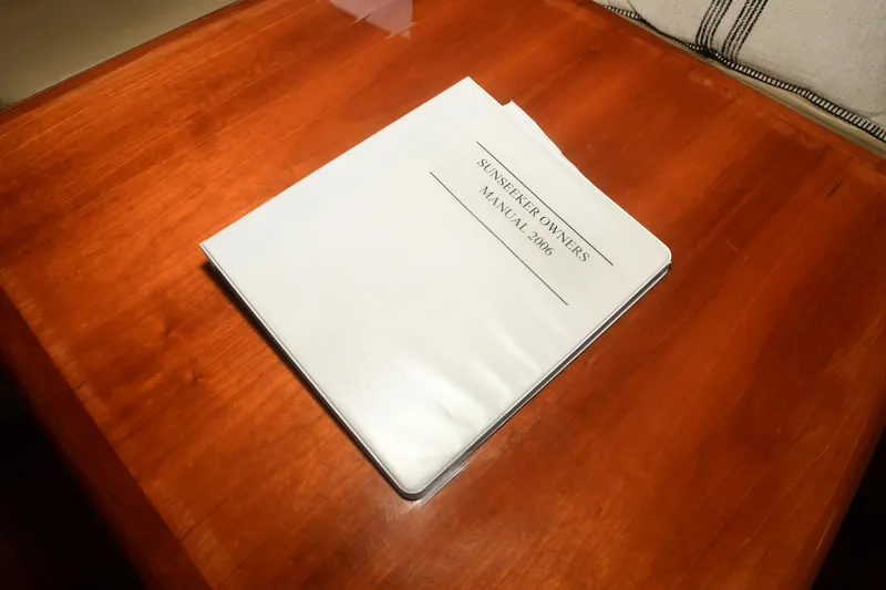 Slide: The Image of Manual for 2006 Sunseeker Manhattan 50 yacht on wooden table. - 12
