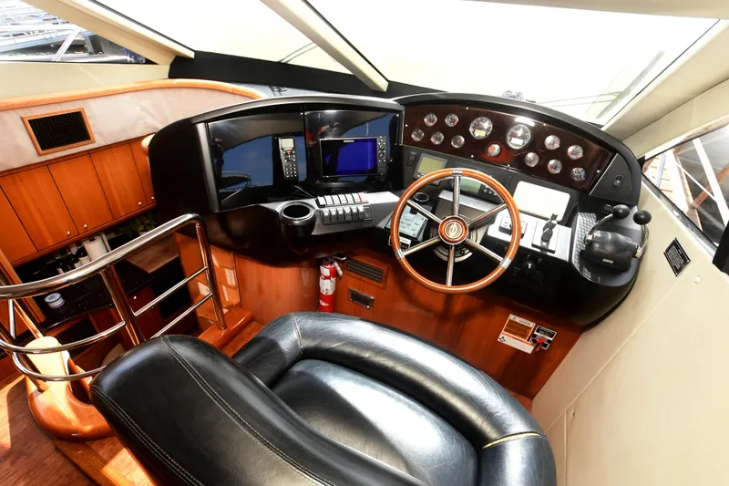 Slide: The Image of Luxurious helm of 2006 Sunseeker Manhattan 50 yacht with leather seating and advanced controls. - 16