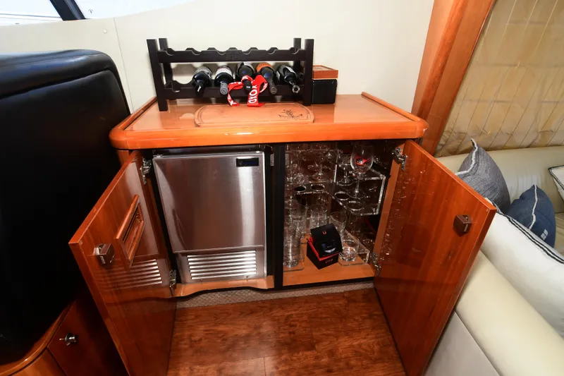 Slide: The Image of Luxurious wooden bar cabinet with wine rack and mini fridge on Sunseeker Manhattan 50 yacht. - 17
