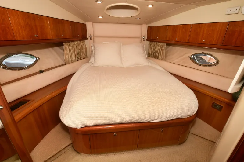 Slide: The Image of Luxurious cabin interior of 2006 Sunseeker Manhattan 50 yacht with cozy bed and wooden accents. - 21
