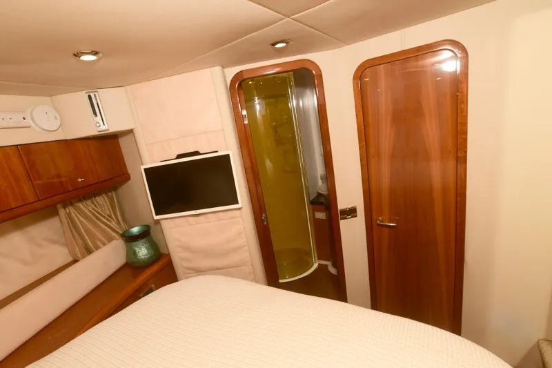 Slide: The Image of Interior of 2006 Sunseeker Manhattan 50 yacht cabin with wood accents and modern amenities. - 23