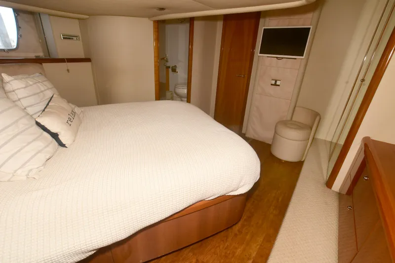 Slide: The Image of Luxurious bedroom interior of 2006 Sunseeker Manhattan 50 yacht with modern amenities. - 29
