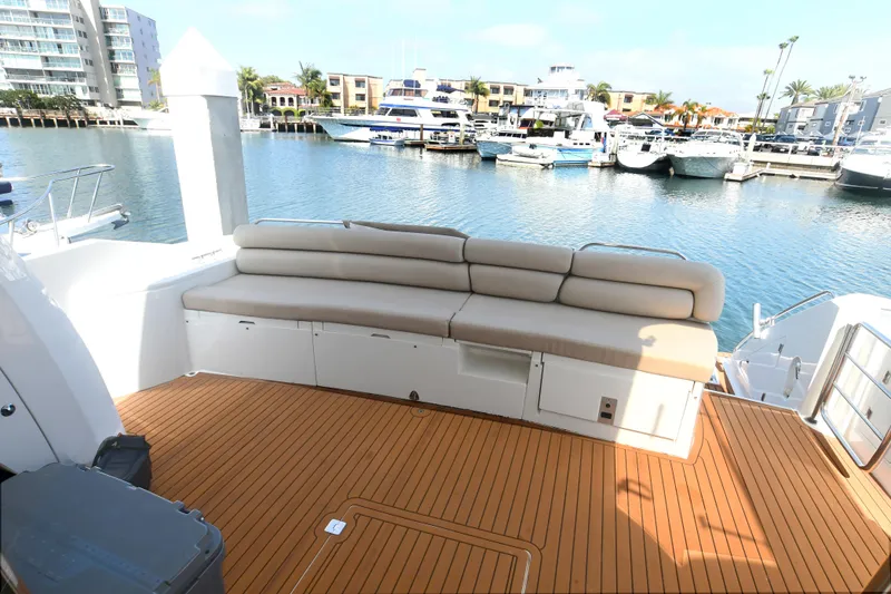 Slide: The Image of Luxurious Sunseeker Manhattan 50 yacht deck with seating, docked in a marina. - 3