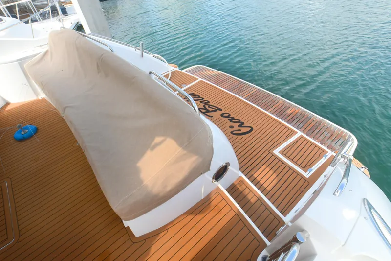 Slide: The Image of Sunseeker Manhattan 50 yacht deck, 2006 model, with teak flooring and covered seating area. - 30