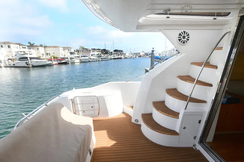 Slide: The Image of Sunseeker Manhattan 50 yacht deck with spiral staircase, docked in a marina, 2006 model. - 32