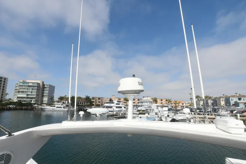 Slide: The Image of Sunseeker Manhattan 50 yacht, 2006 model, docked in a marina with clear blue skies. - 33