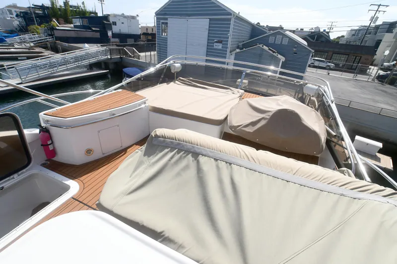 Slide: The Image of Sunseeker Manhattan 50 yacht deck with covered seating, docked at marina, 2006 model. - 37