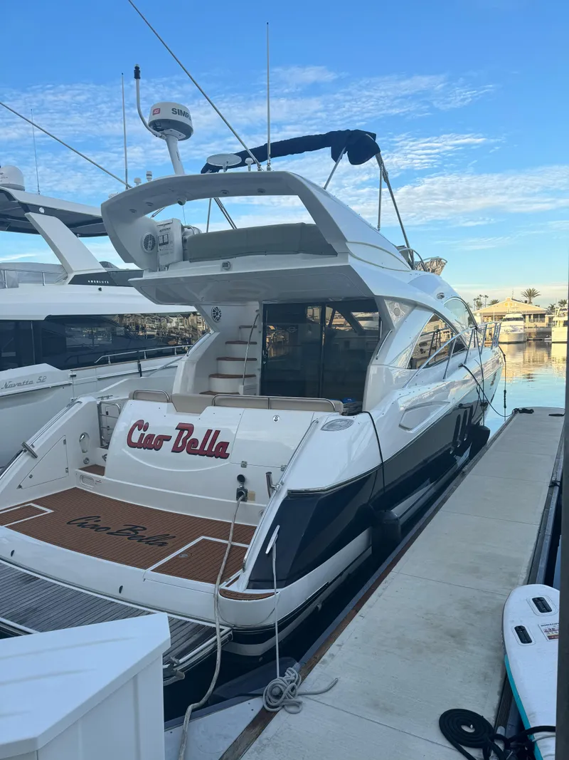 Slide: The Image of 2006 Sunseeker Manhattan 50 yacht docked at marina under clear blue sky. - 4