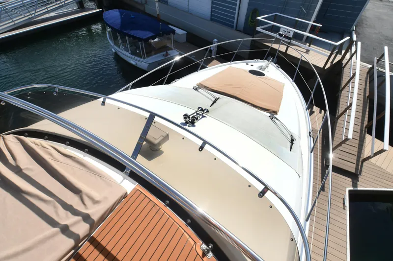 Slide: The Image of 2006 Sunseeker Manhattan 50 yacht docked, showcasing sleek design and spacious deck. - 40