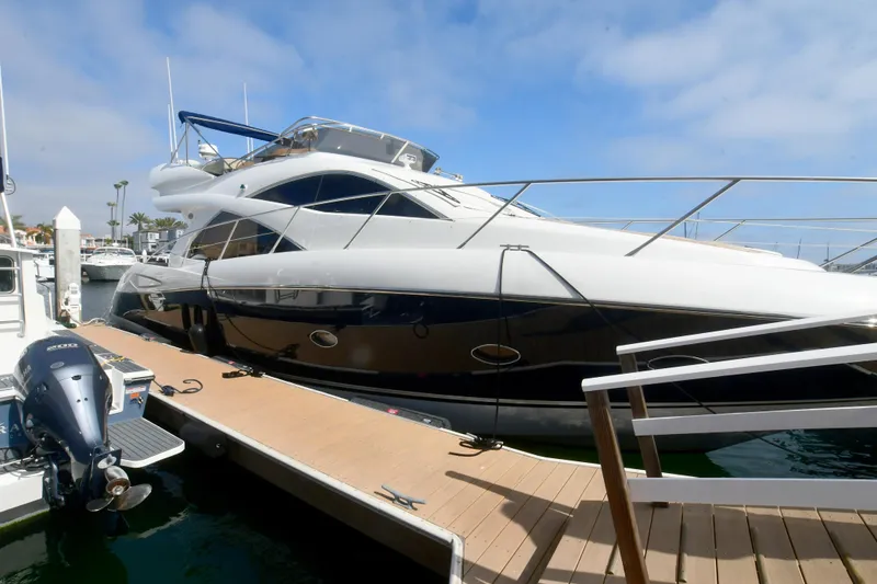 Slide: The Image of 2006 Sunseeker Manhattan 50 yacht docked at marina under blue sky. - 42