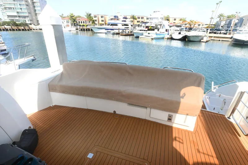 Slide: The Image of Sunseeker Manhattan 50 yacht deck, 2006 model, with covered seating, docked at marina. - 7