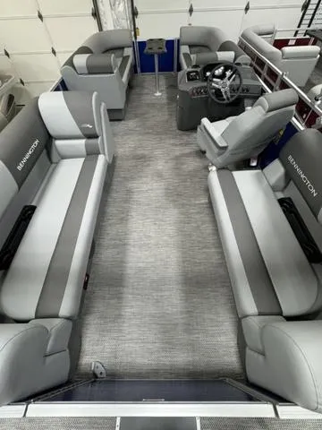 Slide: The Image of 2024 Bennington 20 SVSR pontoon boat with blue cover in a warehouse. - 13