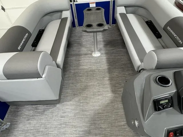 Slide: The Image of 2024 Bennington 20 SVSR pontoon boat interior with gray seating and helm station. - 5