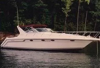 The Image of 1992 Regal Commodore 400 boat on a calm lake with forest background. - 0