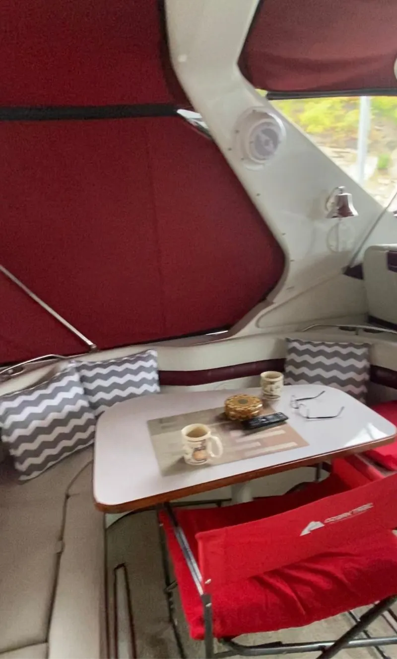 Slide: The Image of Interior of a 1992 Regal Commodore 400 boat with a cozy dining area. - 17