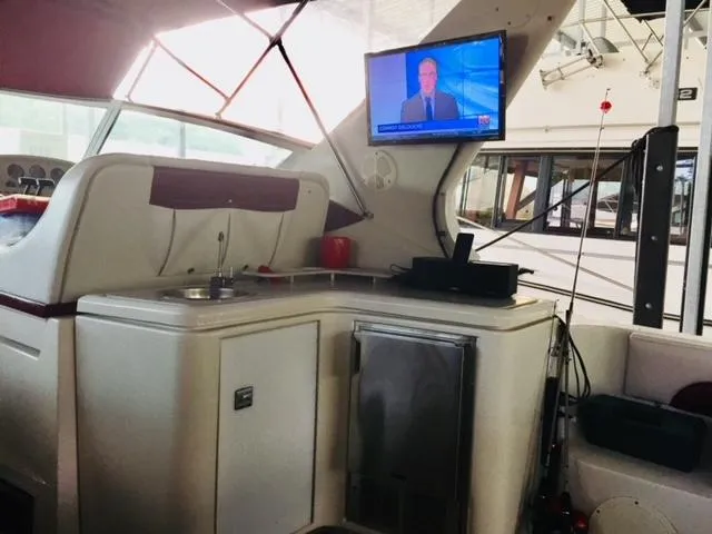 Slide: The Image of Interior of a 1992 Regal Commodore 400 yacht with a TV and kitchenette. - 18