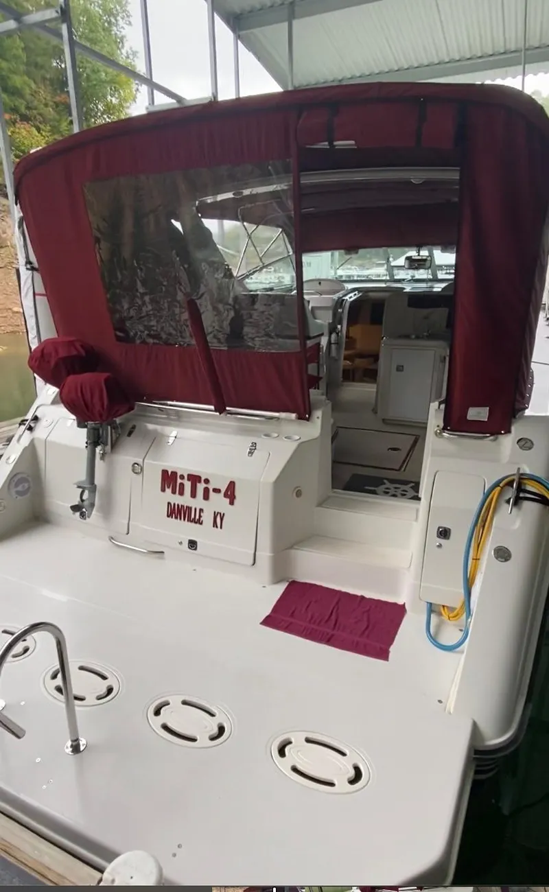 Slide: The Image of 1992 Regal Commodore 400 boat docked with maroon canopy and MITI-4 name. - 19