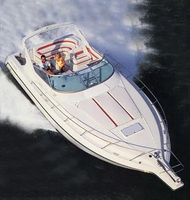 Slide: The Image of 1992 Regal Commodore 400 boat cruising on water, aerial view. - 2