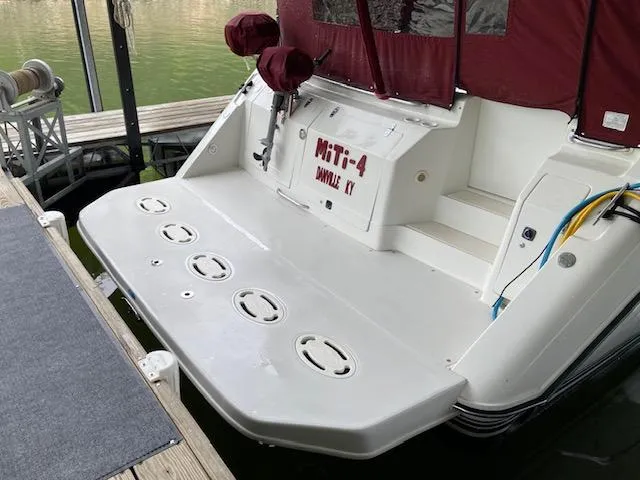 Slide: The Image of 1992 Regal Commodore 400 boat docked, rear view with swim platform and maroon canopy. - 20