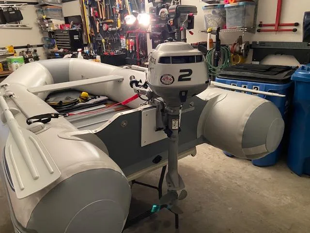 Slide: The Image of Inflatable boat with outboard motor in a garage, Regal Commodore 400, 1992 model. - 21