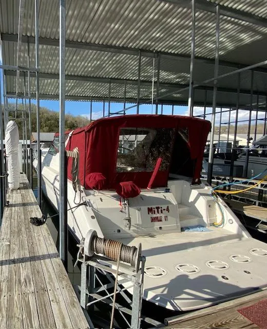 Slide: The Image of 1992 Regal Commodore 400 boat docked with red canopy. - 3